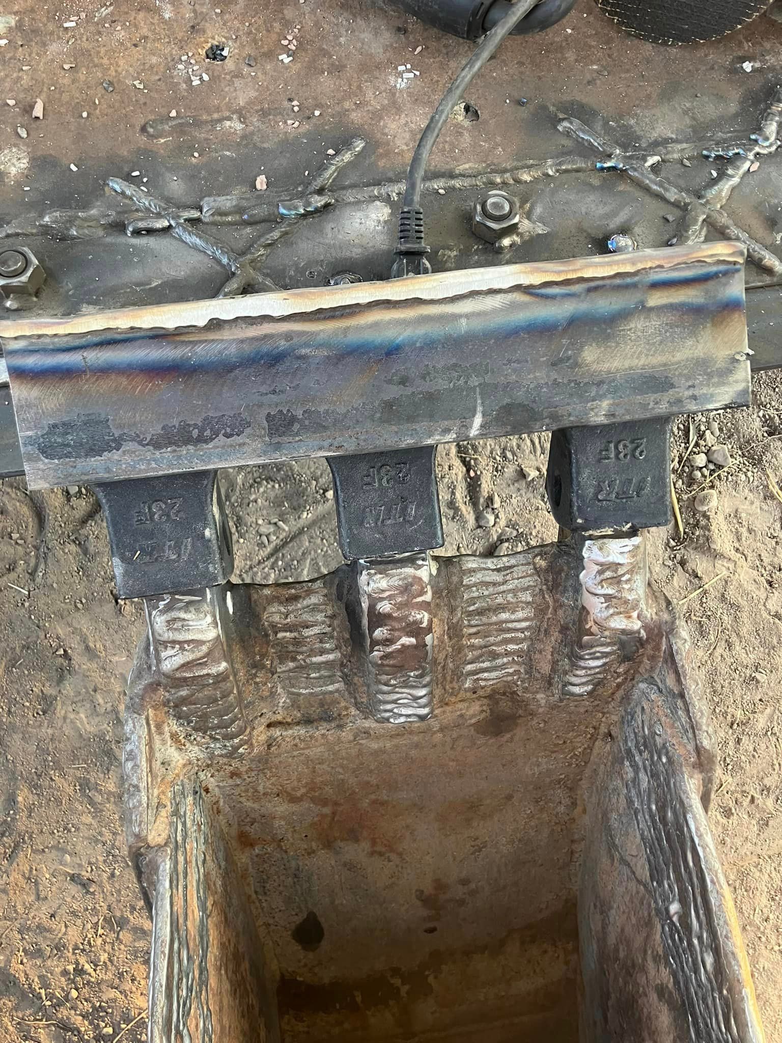 Hard-facing work on excavator bucket teeth