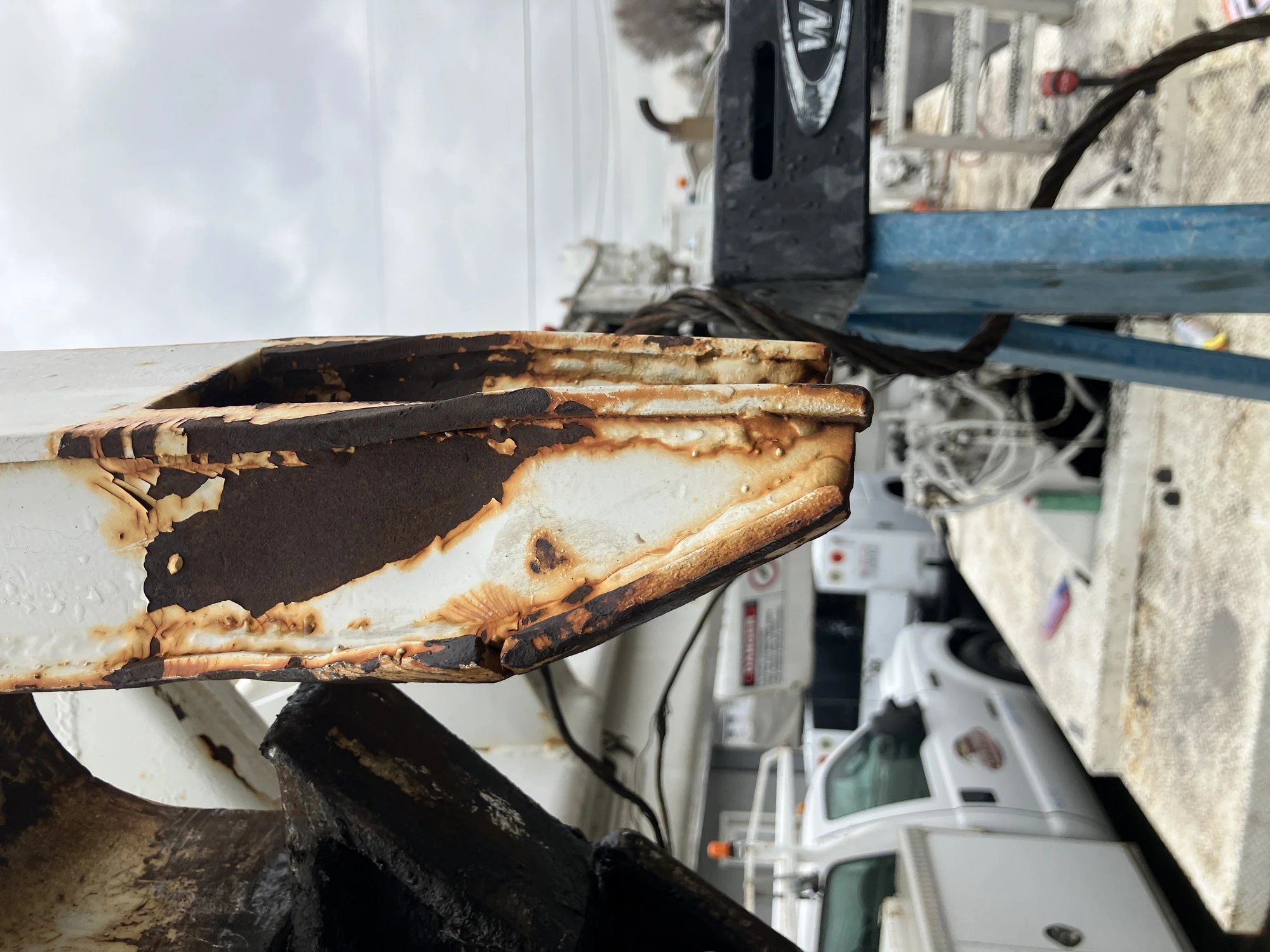 Rusted rack bracket before repair